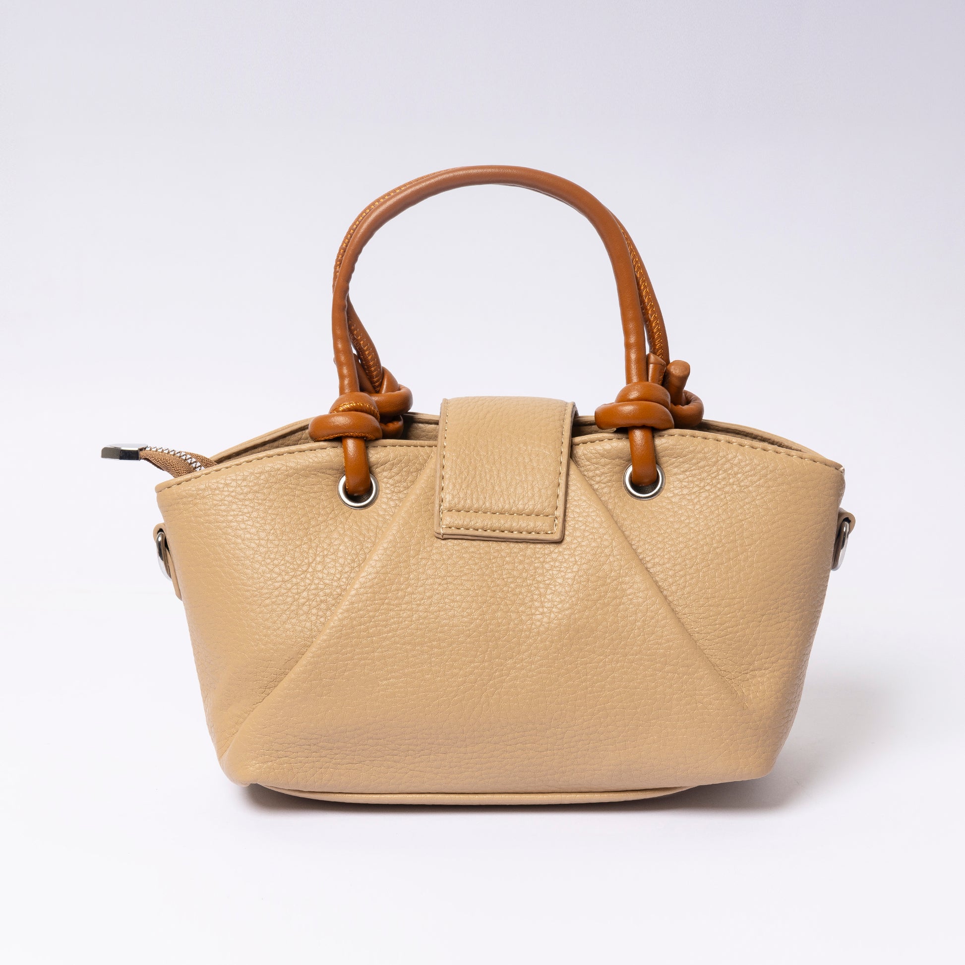 "Avérie Knot Bag Caramel Taupe signature knot handle close-up"
