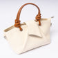 "Avérie Knot Bag Ivory Cream signature knot handle close-up"
